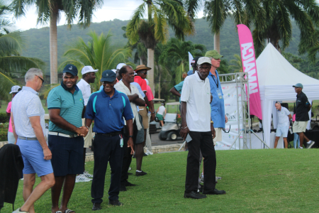 Aqua Bay owner Scott Summy among those watching the leaders at the 18th hole