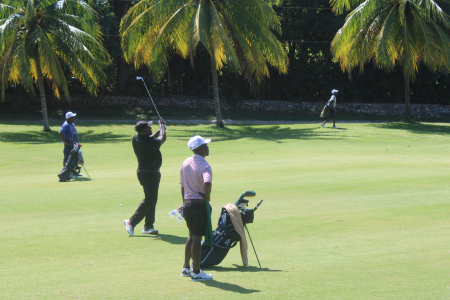 Wesley Brown tracks his ball as he falls right on the green on the 6th hole